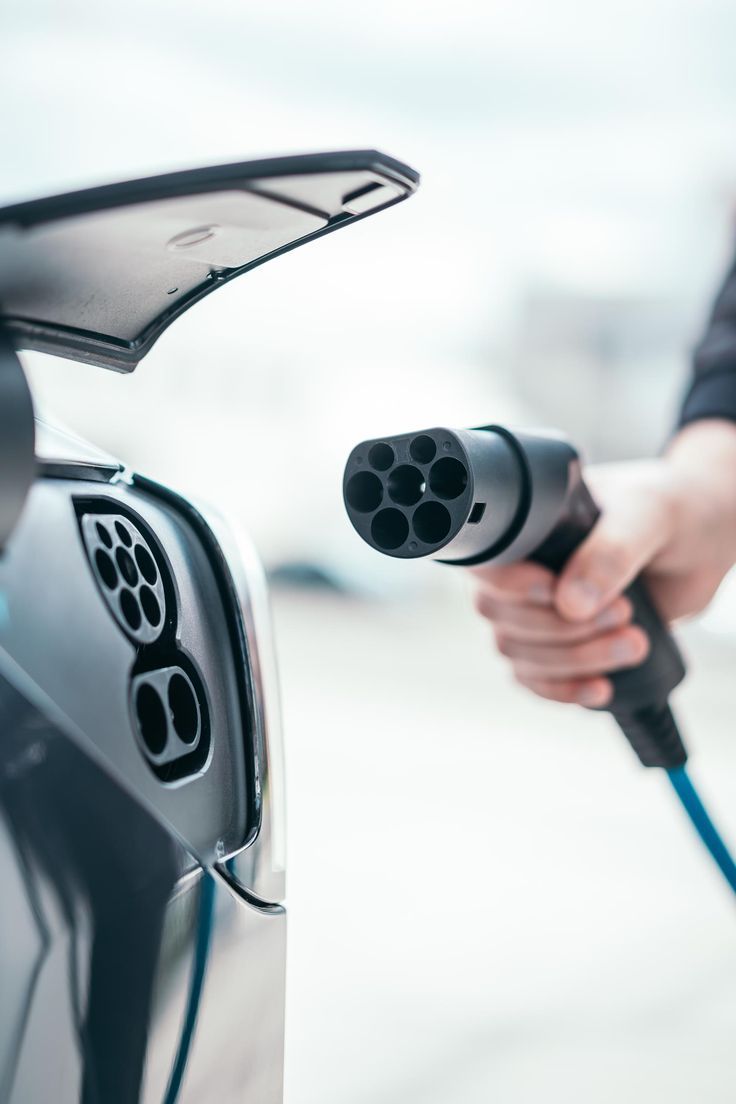EV charging connector being plugged into electric vehicle